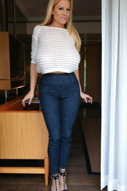 Curvy tall blonde in denim jeans releases her huge F cup tits wearing high heels