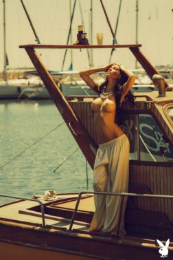 Beautiful sexy babe shows off sexually on a yacht exposing her pierced big boobs