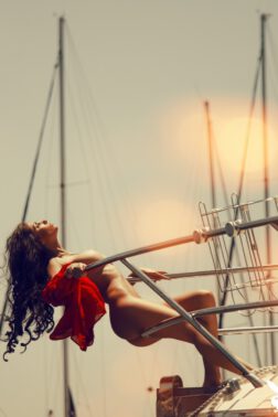 Beautiful sexy babe shows off sexually on a yacht exposing her pierced big boobs
